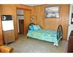 a bed room with a bed and a painting