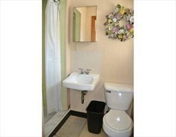 352 Main Street, Unit 10 Clinton, MA 01510 - Photo 4 of 6 a bathroom with a toilet sink and mirror