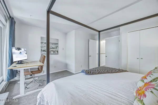 a bedroom with a bed and a table in it