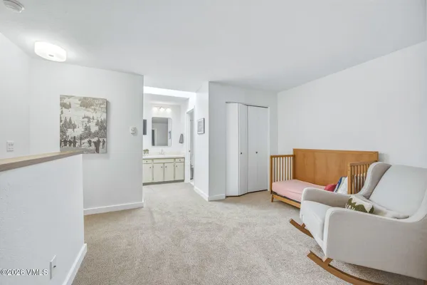 a living room with furniture and a bathroom