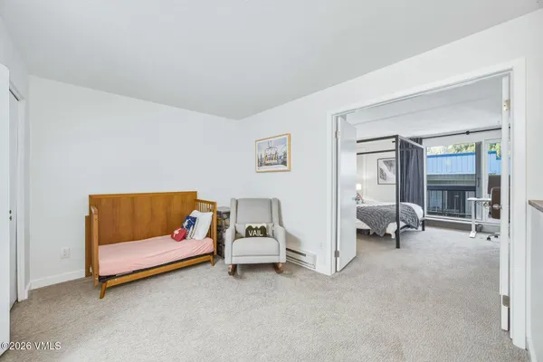 a bedroom with furniture and a lamp