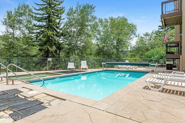 a view of a swimming pool with a lounge chair