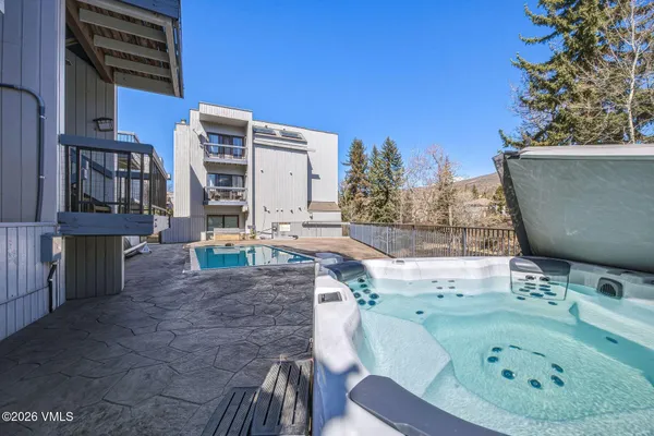 a backyard of a house with table and chairs