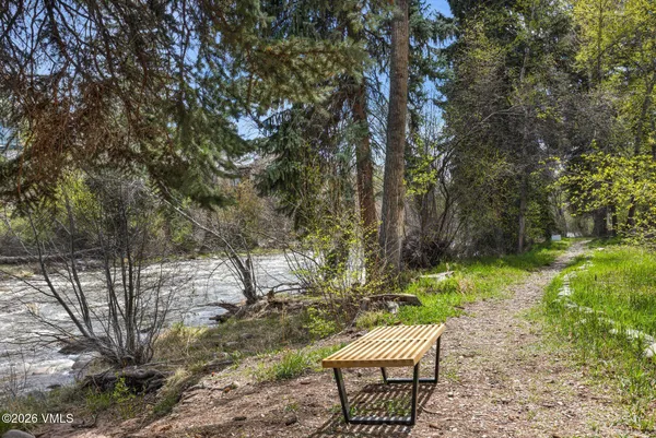 a wooden bench sitting in the middle of a yard