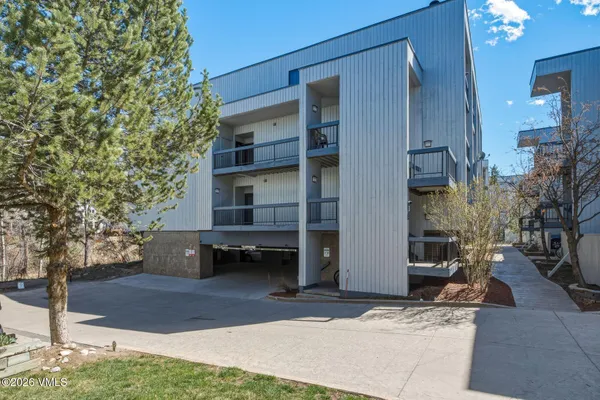 a backyard of a house with barbeque oven and outdoor seating