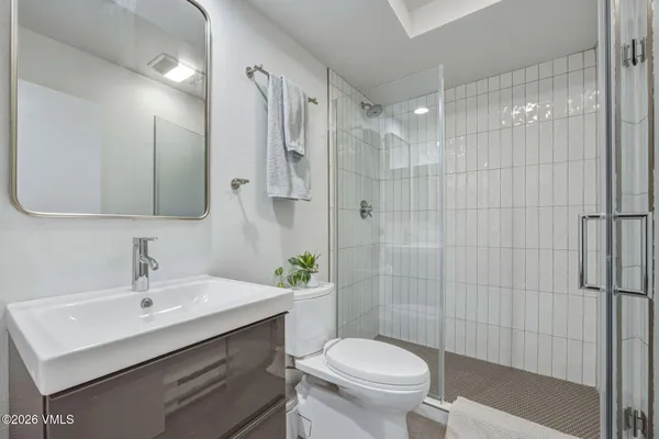 a bathroom with a sink toilet and shower