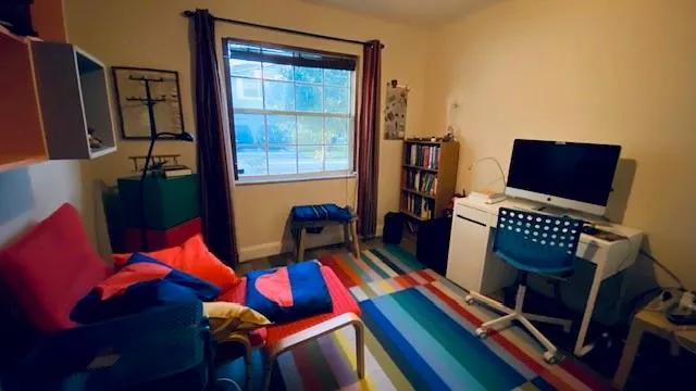 a living room with furniture and a floor to ceiling window