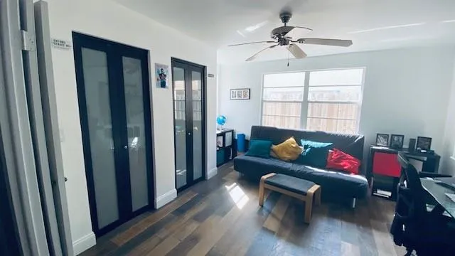 a living room with furniture and wooden floor