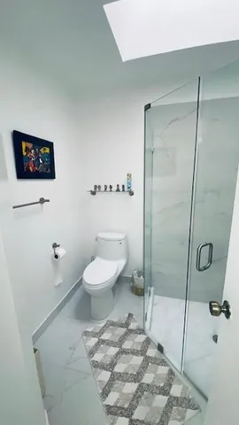 a bathroom with a toilet a sink and a shower
