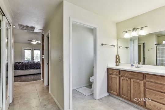 1214 North Guam Street Ridgecrest, CA 93555 - Photo 42 of 48 a en suite bathroom with a double vanity sink and a mirror