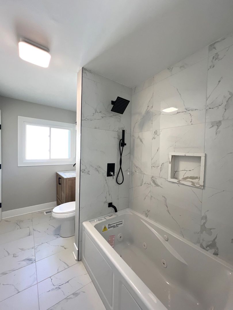 290 Merrill Avenue Calumet City, IL 60409 - Photo 11 of 18 a bathroom with a granite countertop toilet a sink and bathtub