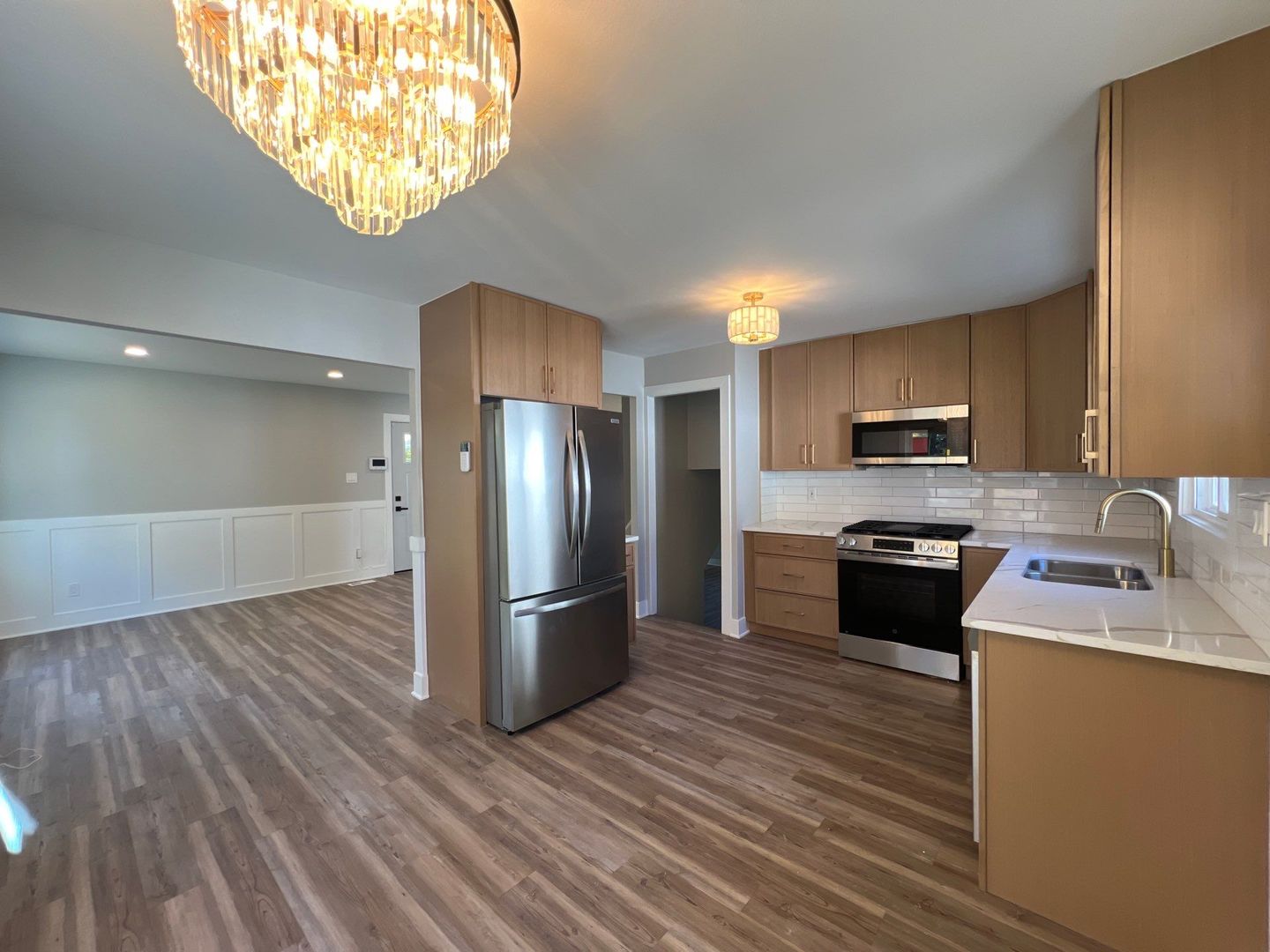 290 Merrill Avenue Calumet City, IL 60409 - Photo 3 of 18 a kitchen with stainless steel appliances granite countertop a refrigerator a stove a sink and a microwave oven