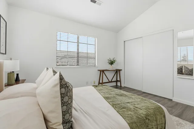 a bedroom with a bed and a night stand