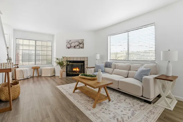 a living room with furniture a rug and a fireplace