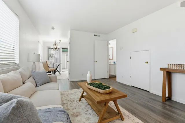 a living room with furniture and a wooden floor