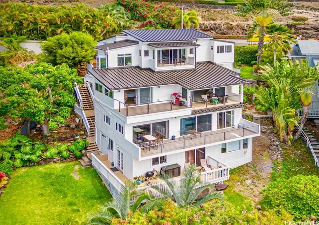 a aerial view of a house with yard and balcony