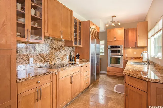 a kitchen with stainless steel appliances granite countertop a sink and cabinets