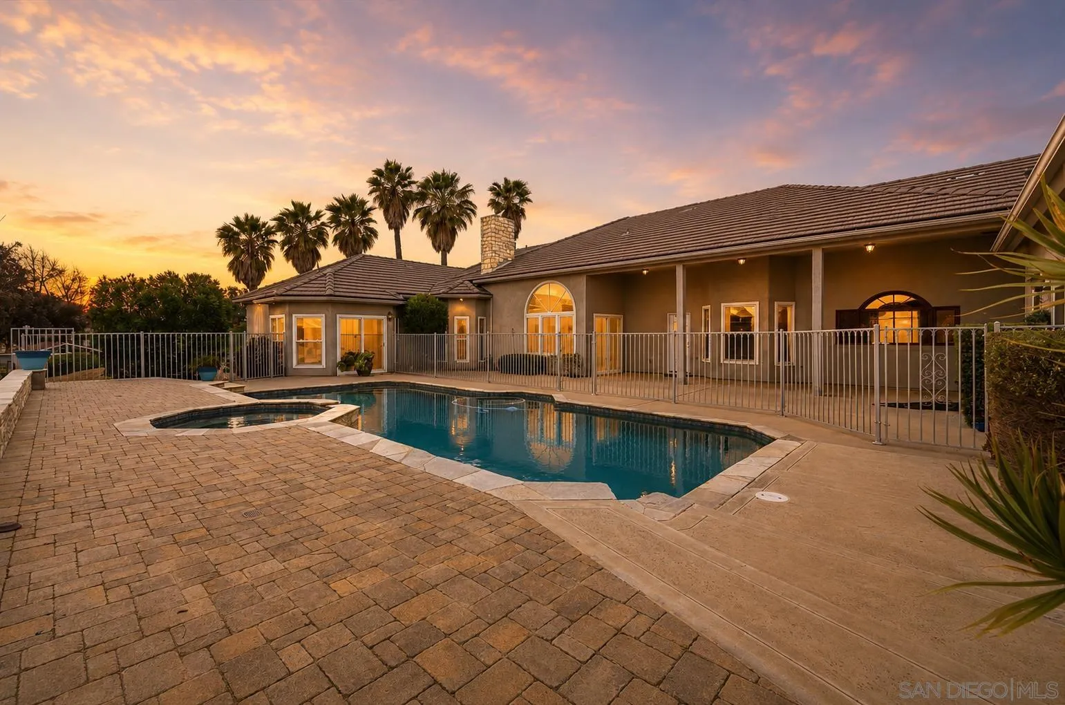 a view of a house with swimming pool and sitting area