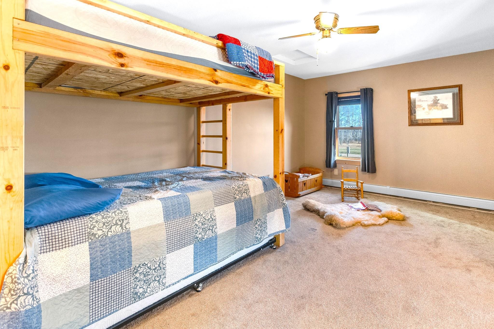 6014 Brown Road Kettle River, MN 55757 - Photo 19 of 54 Carpeted bedroom featuring ceiling fan and a baseboard heating unit
