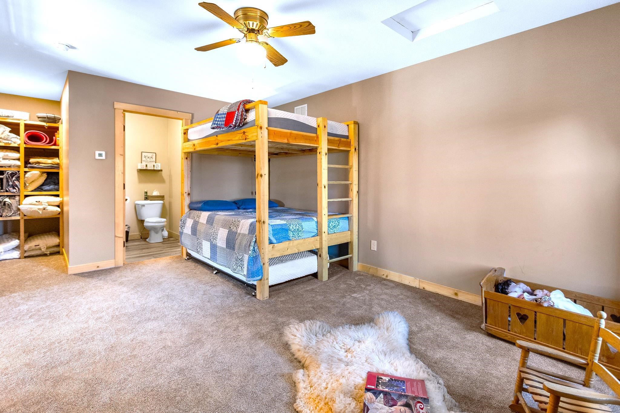 6014 Brown Road Kettle River, MN 55757 - Photo 21 of 54 Bedroom with carpet, a ceiling fan, and attic access