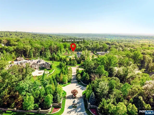 an aerial view of residential house with outdoor space and trees