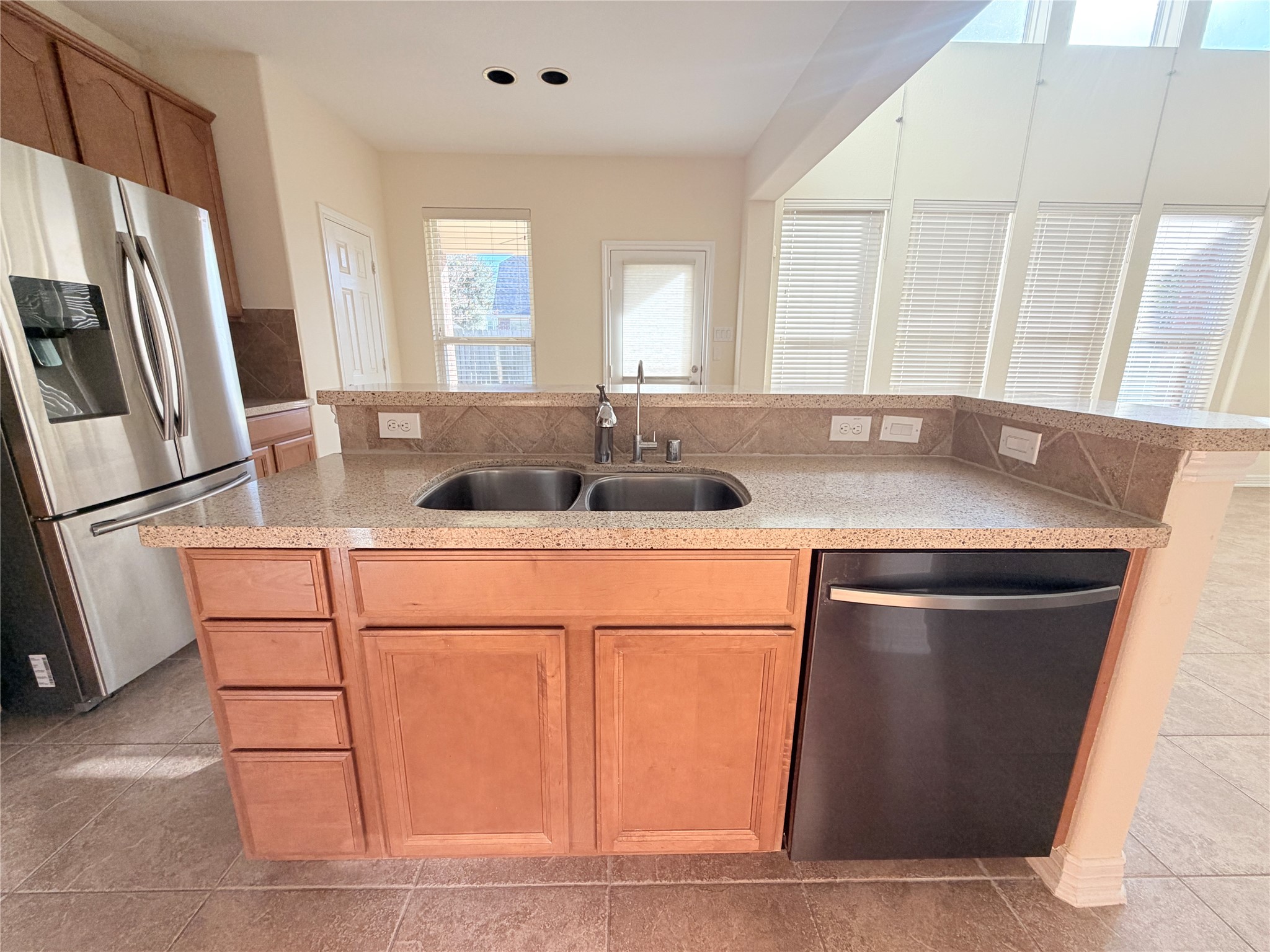 28015 Silverstream Court Fulshear, TX 77441 - Photo 8 of 33 a kitchen with stainless steel appliances granite countertop a sink and a refrigerator
