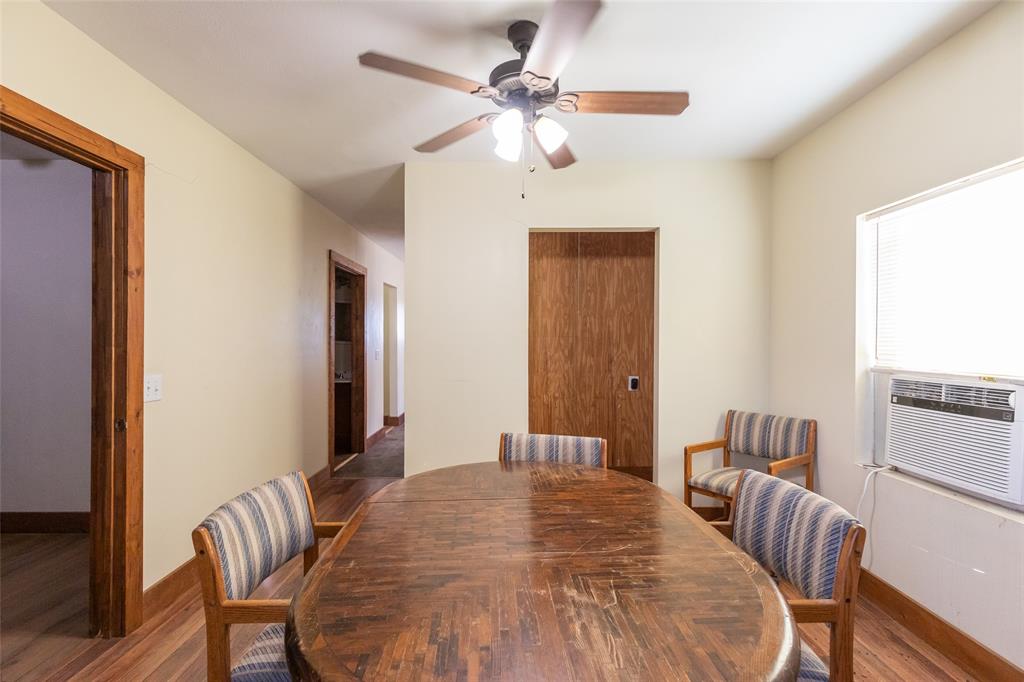 640 Ground Street Moran, TX 76464 - Photo 10 of 35 Interior space featuring wood-finish flooring, light-toned walls, and a ceiling fan with integrated lighting