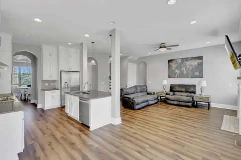 a kitchen with stainless steel appliances granite countertop a sink and a white cabinets
