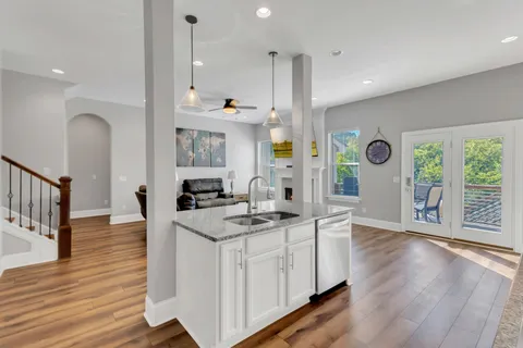 a kitchen with white cabinets and refrigerator