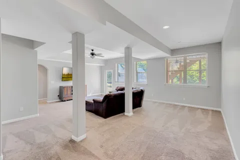 a bathroom with a sink a toilet a mirror and shower