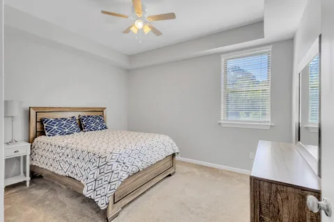 a bedroom with a bed and a ceiling fan in it
