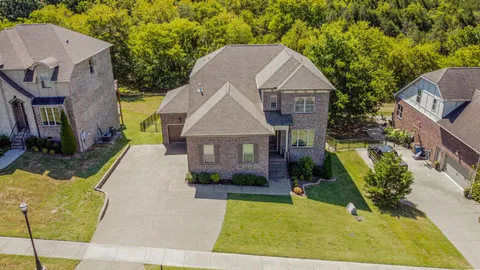 a view of a backyard with swimming pool and outdoor space