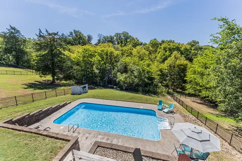 a view of a livingroom with wooden floor and an entryway