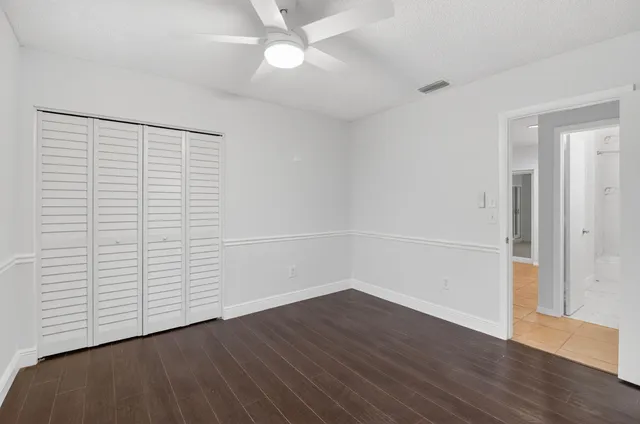 a bathroom with a sink a toilet and a large mirror