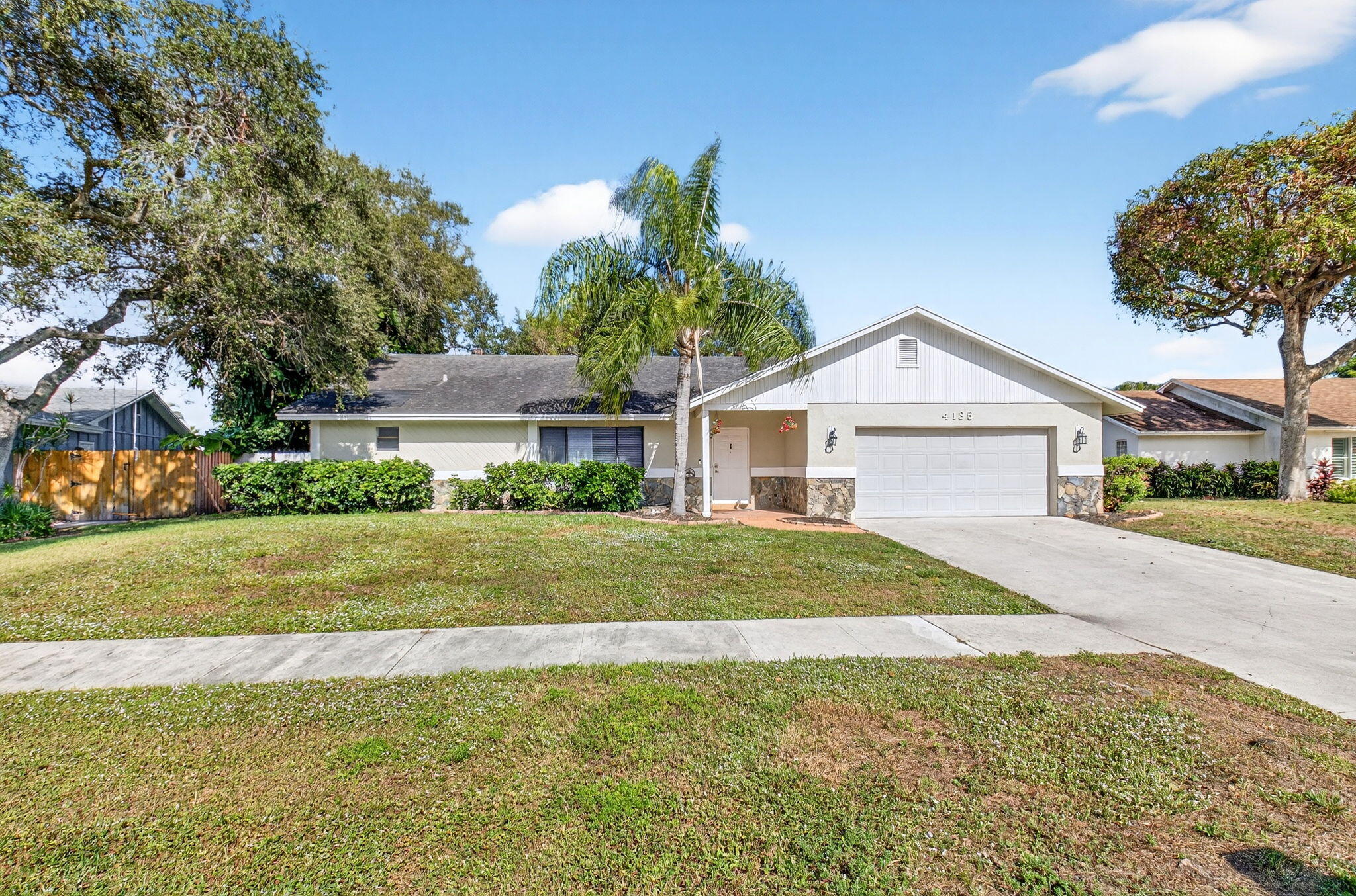 4135 Bay Laurel Way Boca Raton, FL 33487 - Photo 2 of 52 a front view of a house with a yard and garage