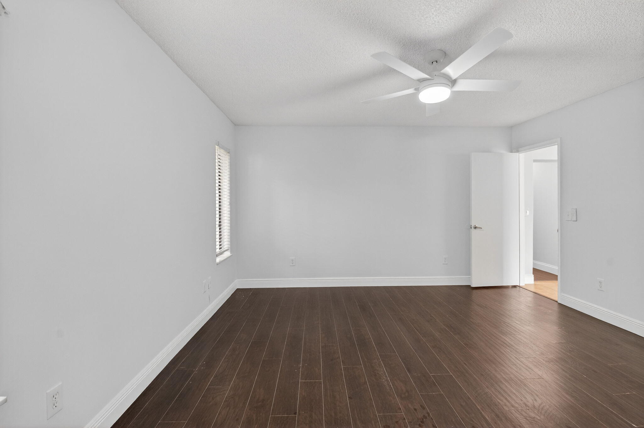 4135 Bay Laurel Way Boca Raton, FL 33487 - Photo 25 of 52 an empty room with wooden floor and windows