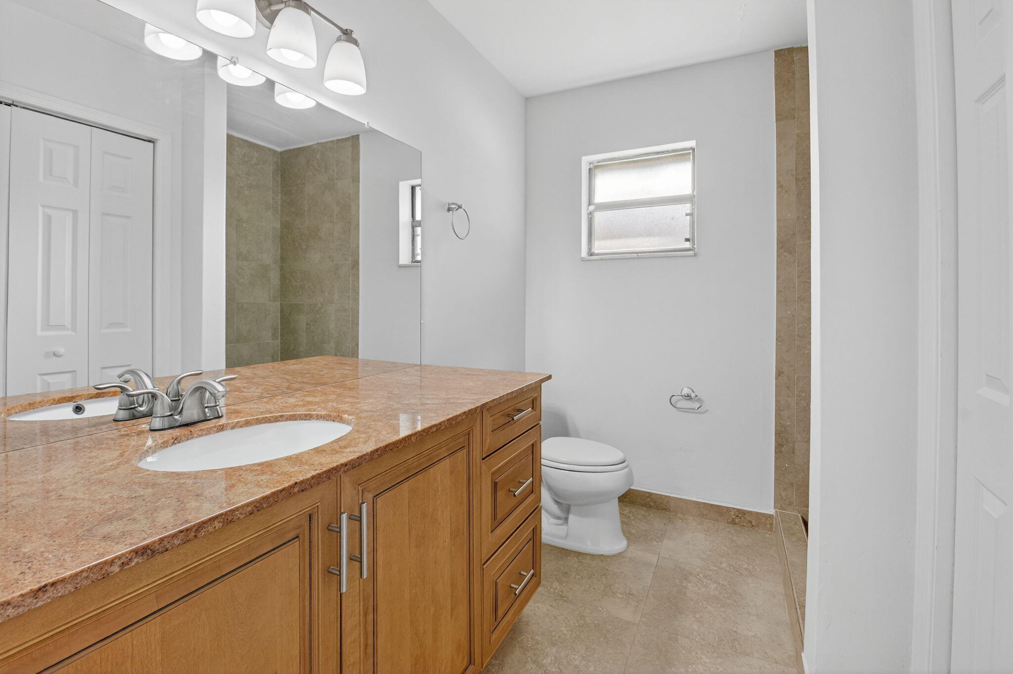 4135 Bay Laurel Way Boca Raton, FL 33487 - Photo 26 of 52 a bathroom with a granite countertop sink a toilet and a mirror
