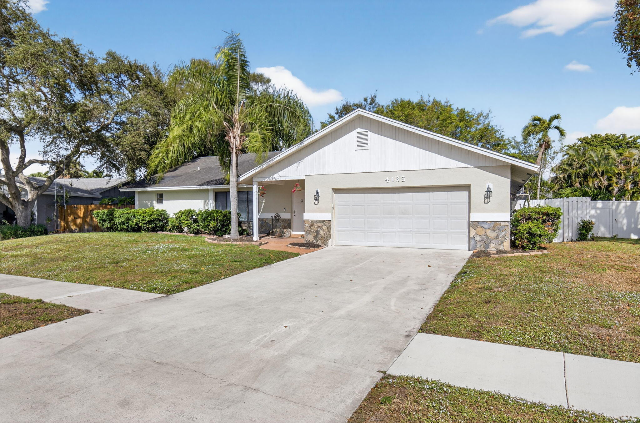 4135 Bay Laurel Way Boca Raton, FL 33487 - Photo 3 of 52 a front view of a house with a yard and garage