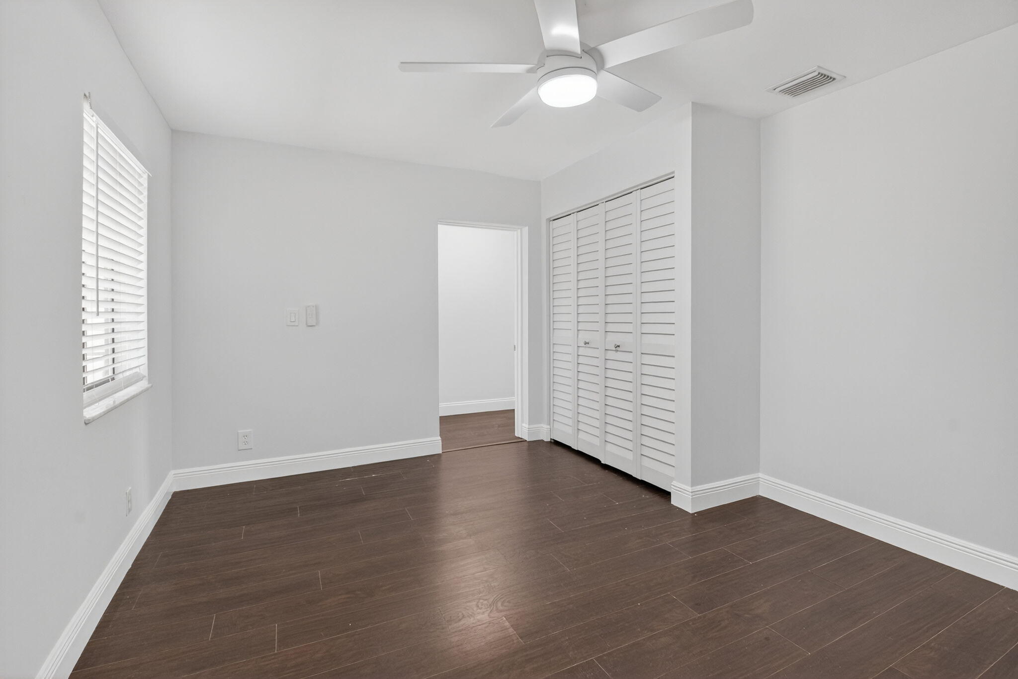 4135 Bay Laurel Way Boca Raton, FL 33487 - Photo 31 of 52 an empty room with wooden floor and windows