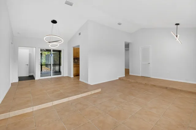 a kitchen with stainless steel appliances granite countertop a sink and a stove top oven with wooden floor