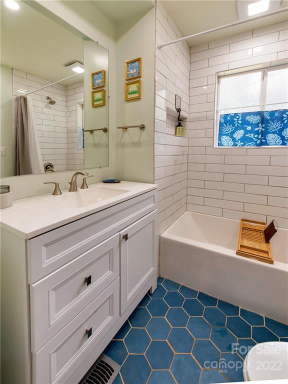 3501 Mathis Drive Charlotte, NC 28208 - Photo 22 of 42 a bathroom with a sink a bathtub and a shower
