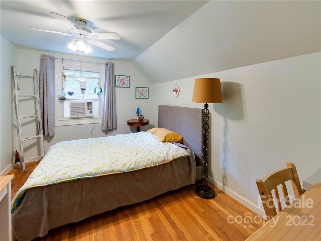 3501 Mathis Drive Charlotte, NC 28208 - Photo 28 of 42 a bed sitting in a bedroom next to a window with a flat screen tv