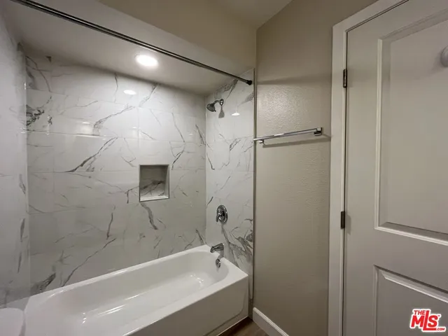 a bathroom with a bathtub and a shower
