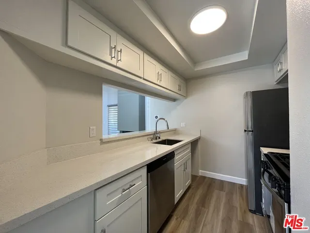 a kitchen with a sink and cabinets
