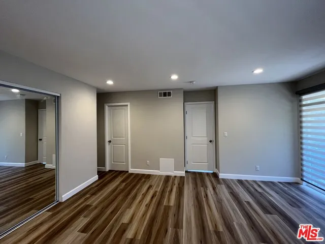a view of a room with wooden floor