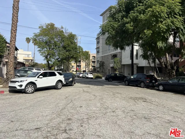 a view of street with parked cars
