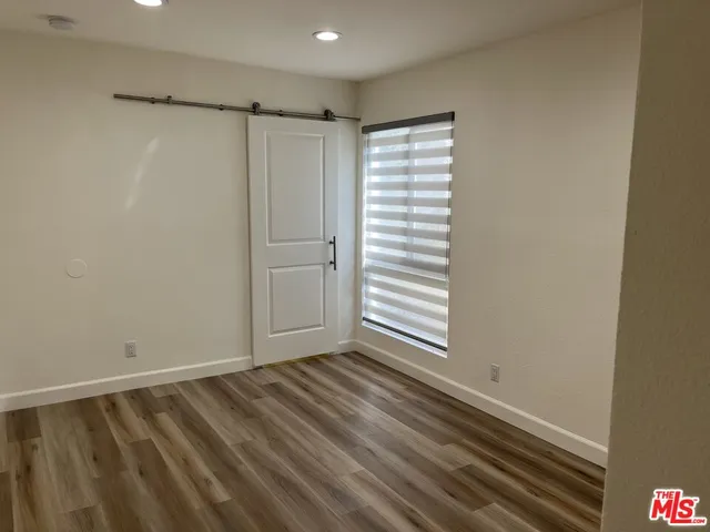 a view of a room with an empty space and a window