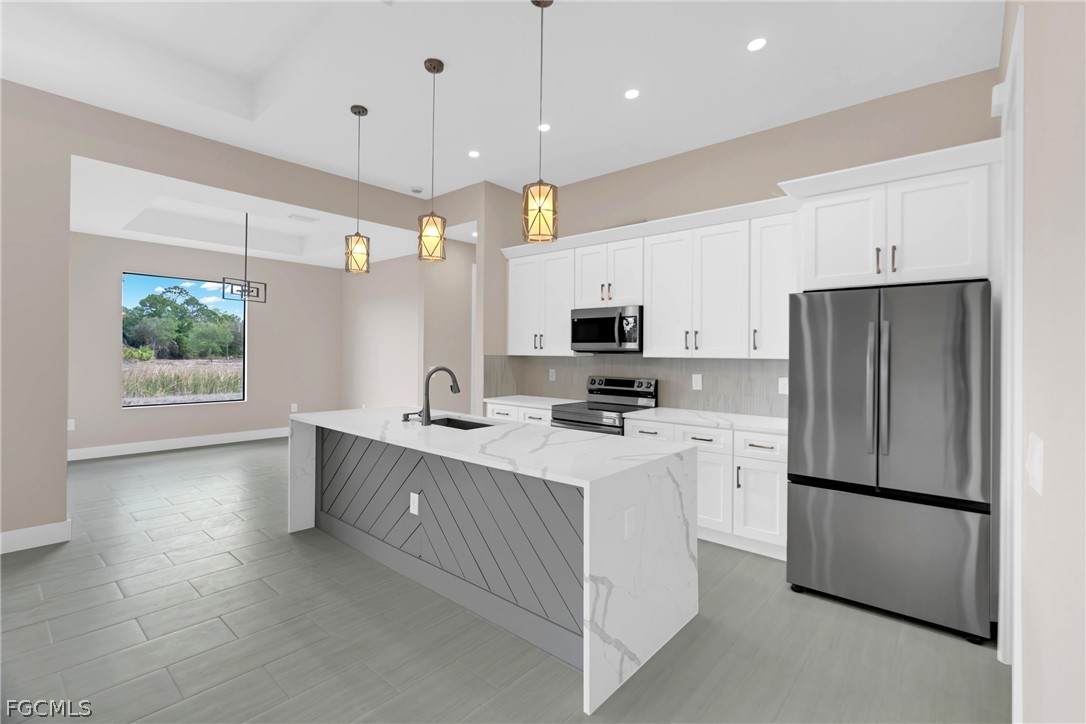 6029 Keystone Circle LaBelle, FL 33935 - Photo 17 of 50 a kitchen with a refrigerator a sink and dishwasher with wooden floor