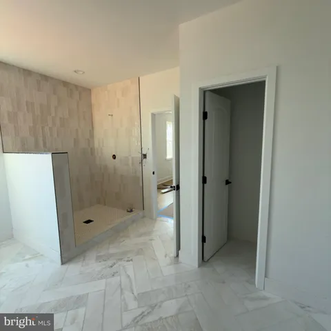 a bathroom with a shower and a glass door
