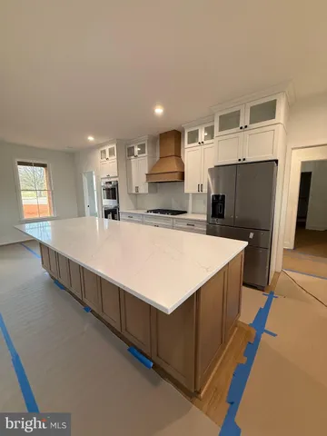 a large white kitchen with a large window